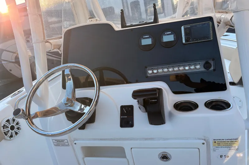 Slide: The Image of 2018 Tidewater 210 LXF boat dashboard with steering wheel and control panel. - 5