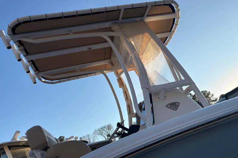 Slide: The Image of 2018 Tidewater 210 LXF boat with T-top against clear blue sky. - 6