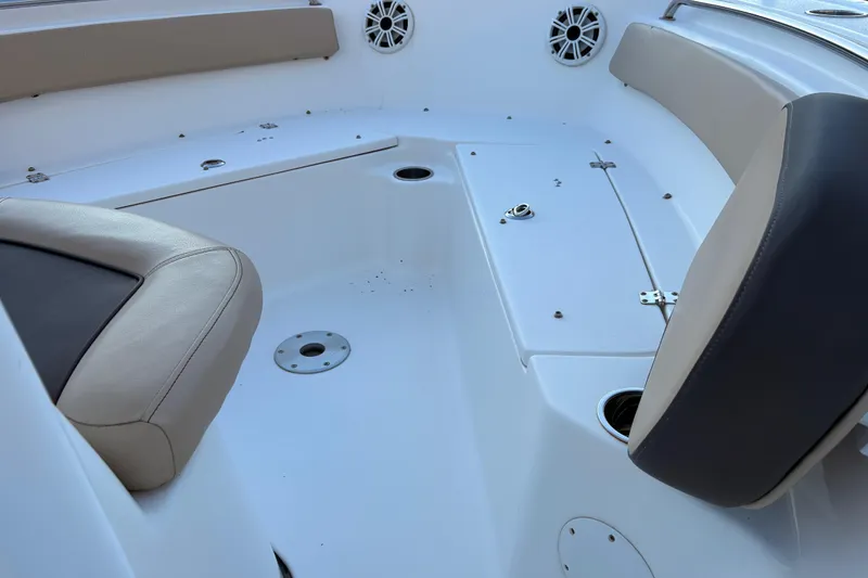Slide: The Image of 2018 Tidewater 210 LXF boat interior with cushioned seating and speaker system. - 9