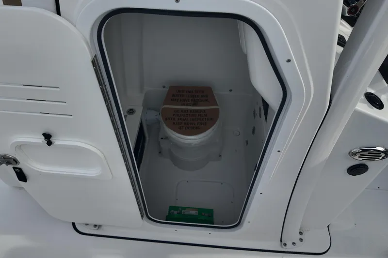 Slide: The Image of 2026 Blazer 2600 Makaira boat with Mercury engine, featuring tan seating and spacious deck. - 12