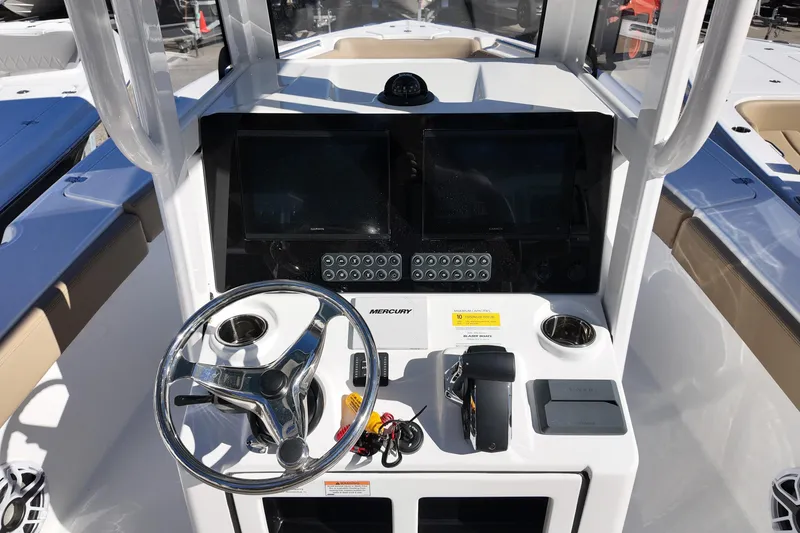 Slide: The Image of 2026 Blazer Bay Makaira 2600 boat console with steering wheel and dual displays. - 15