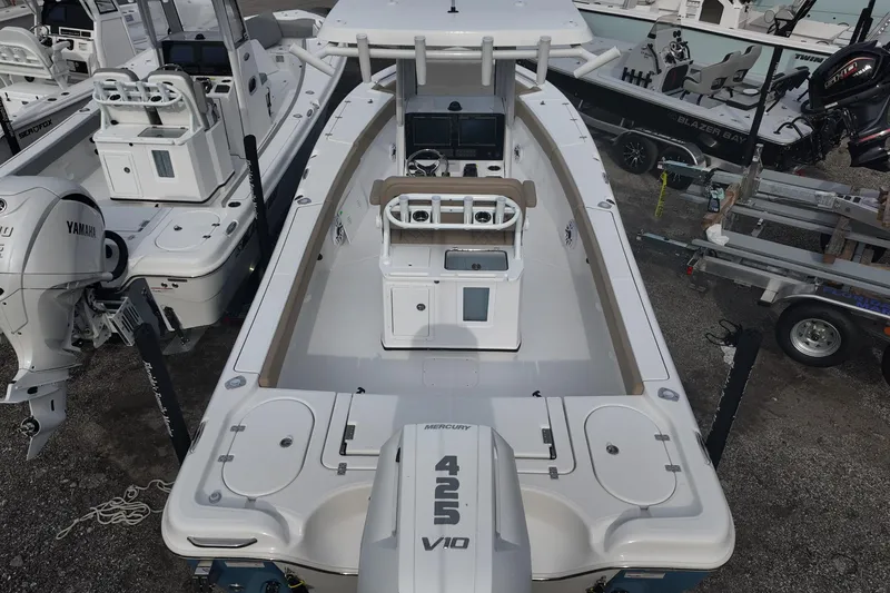 Slide: The Image of 2026 Blazer 2600 Makaira boat docked, featuring sleek design and Mercury outboard engine. - 2