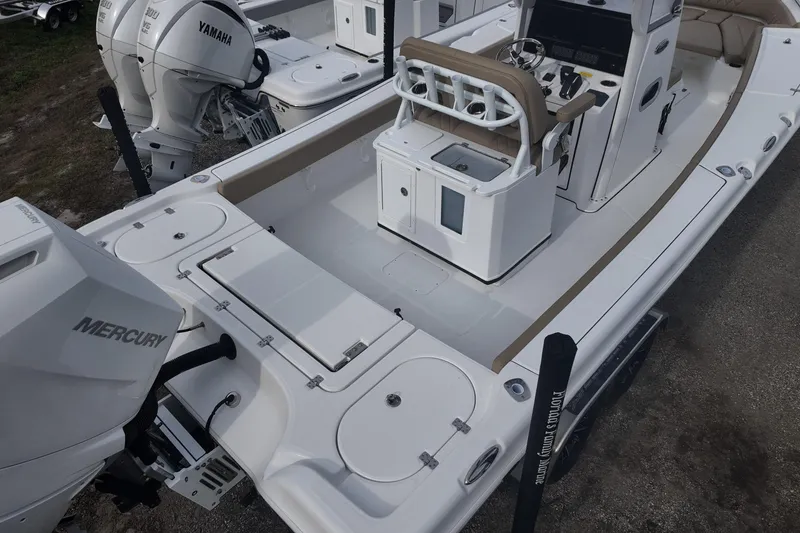 Slide: The Image of 2026 Blazer 2600 Makaira boat on trailer, featuring dual engines, parked outdoors. - 4