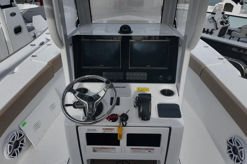 Slide: The Image of 2026 Blazer 2600 Makaira boat with tan seating, displayed outdoors on a trailer. - 8