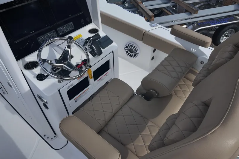 Slide: The Image of Interior view of 2026 Blazer 2600 Makaira boat with beige seating. - 9