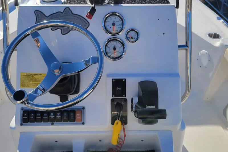 Slide: The Image of 2024 Key West 188 Bay Reef boat dashboard with steering wheel and Yamaha controls. - 9