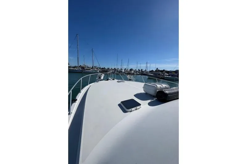 Slide: The Image of 1996 Viking 50 Sport Fisher Convertible yacht cruising on calm blue waters. - 10