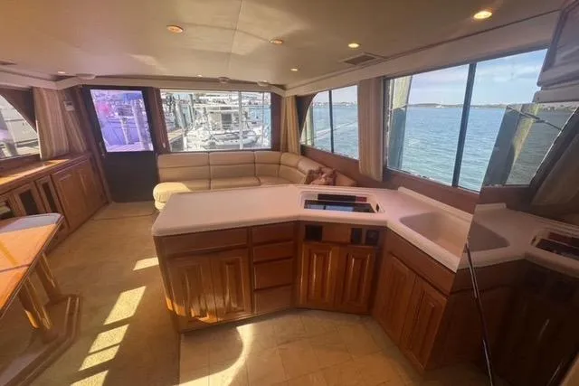 Slide: The Image of 1996 Viking 50 Sport Fisher Convertible yacht on open water, bridge in background. - 12