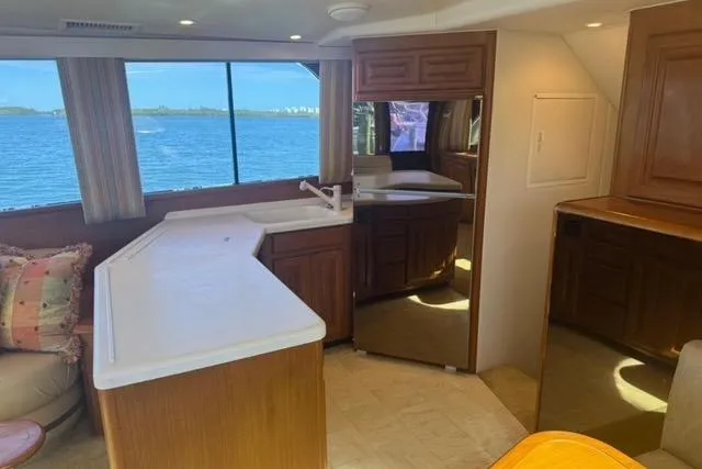 Slide: The Image of 1996 Viking 50 Sport Fisher Convertible cruising on open water. - 13