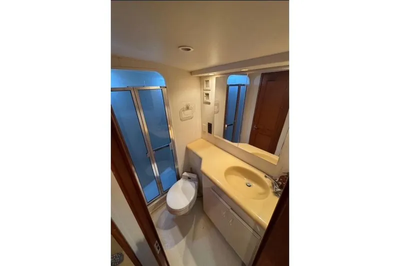 Slide: The Image of 1996 Viking 50 Sport Fisher Convertible cruising on open water under cloudy skies. - 16