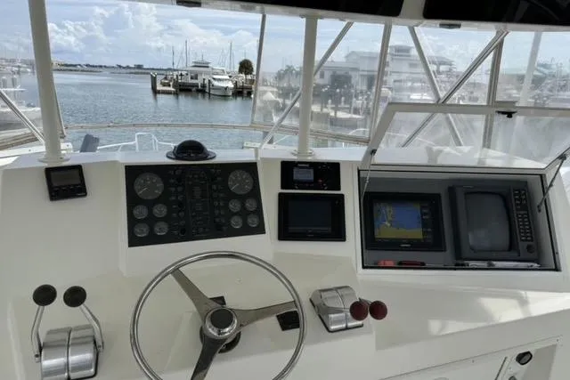 Slide: The Image of 1996 Viking 50 Sport Fisher Convertible cruising on open water. - 2