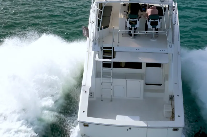 Slide: The Image of 1996 Viking 50 Sport Fisher Convertible cruising on open water, rear view. - 29