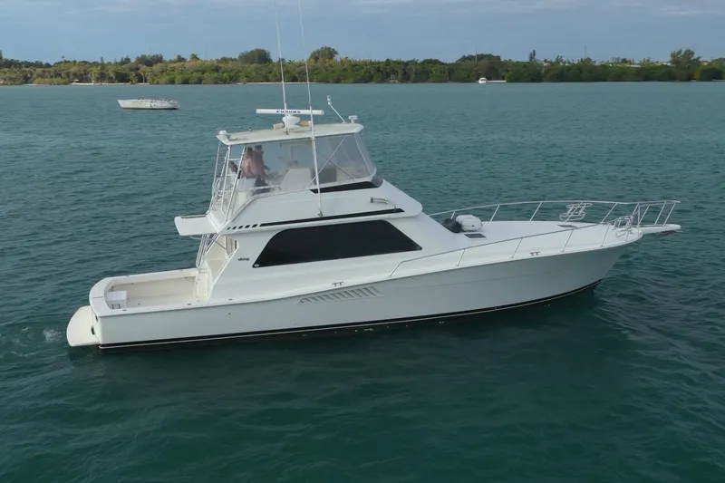 Slide: The Image of 1996 Viking 50 Sport Fisher Convertible yacht cruising on calm waters. - 30