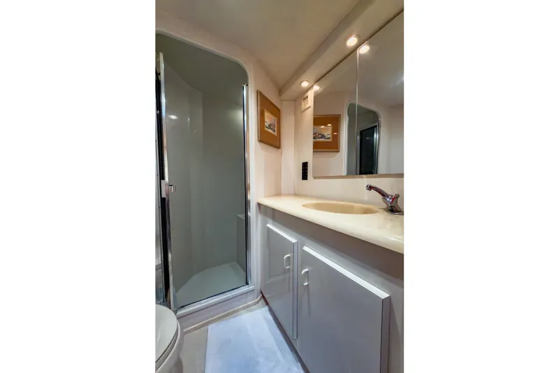 Slide: The Image of Bathroom interior of 1996 Viking 50 Sport Fisher Convertible yacht, featuring shower and vanity. - 38