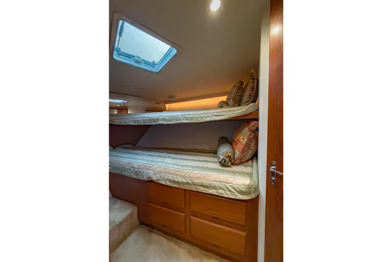 Slide: The Image of Bunk beds in 1996 Viking 50 Sport Fisher yacht cabin with skylight and storage drawers. - 43
