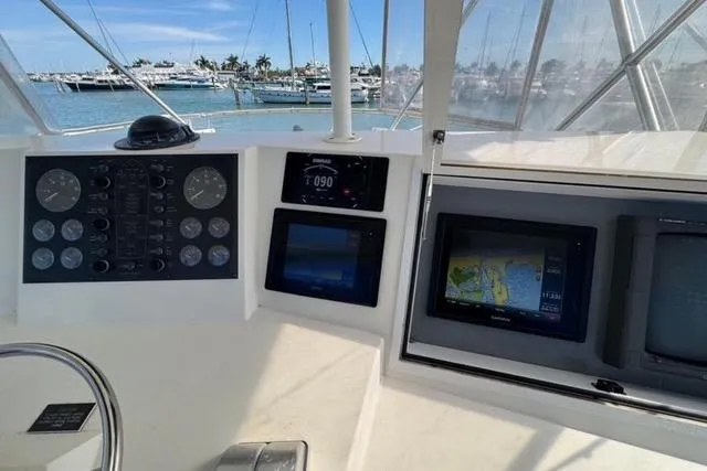 Slide: The Image of 1996 Viking 50 Sport Fisher Convertible cruising on open water. - 5