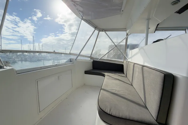 Slide: The Image of 1996 Viking 50 Sport Fisher Convertible boat interior with cushioned seating and marina view. - 50