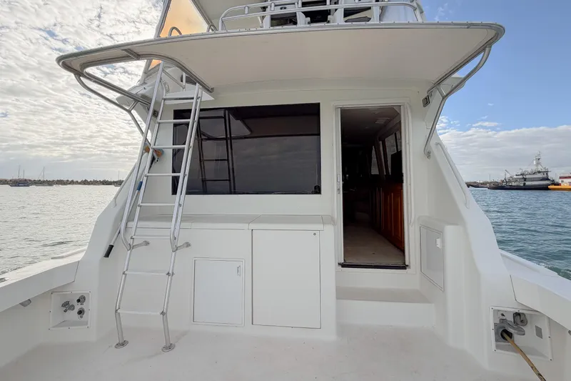 Slide: The Image of 1996 Viking 50 Sport Fisher Convertible boat with ladder and open cabin door. - 53