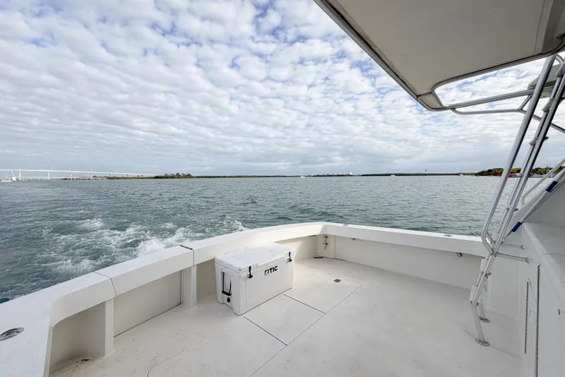 Slide: The Image of 1996 Viking 50 Sport Fisher Convertible boat on open water under cloudy sky. - 54
