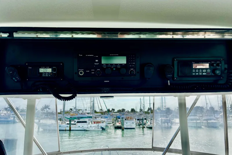 Slide: The Image of Control panel of a 1996 Viking 50 Sport Fisher Convertible with marina view. - 59