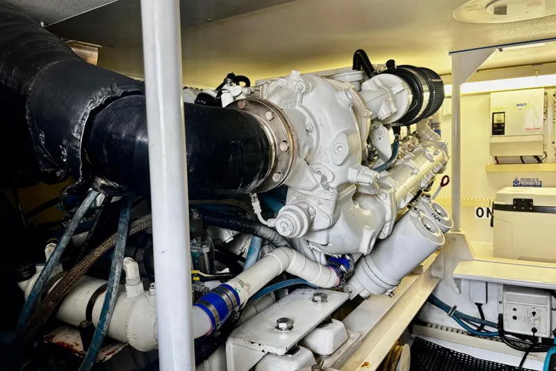 Slide: The Image of Engine room of a 1996 Viking 50 Sport Fisher Convertible boat, showcasing machinery and components. - 61