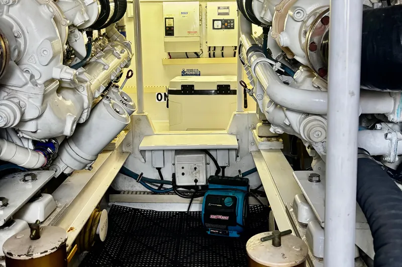 Slide: The Image of Engine room of a 1996 Viking 50 Sport Fisher Convertible boat, showcasing machinery and equipment. - 63