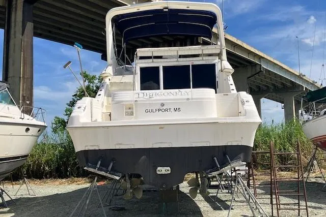 Slide: The Image of 1997 Sea Ray 440 Express yacht on stands, Gulfport, MS, under bridge. - 1