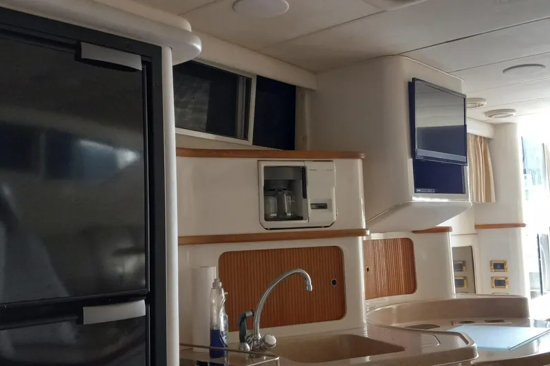 Slide: The Image of Interior of 1997 Sea Ray 440 Express yacht with kitchen amenities. - 12