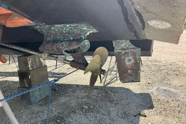 Slide: The Image of 1997 Sea Ray 440 Express boat propeller and rudder on dry dock. - 3