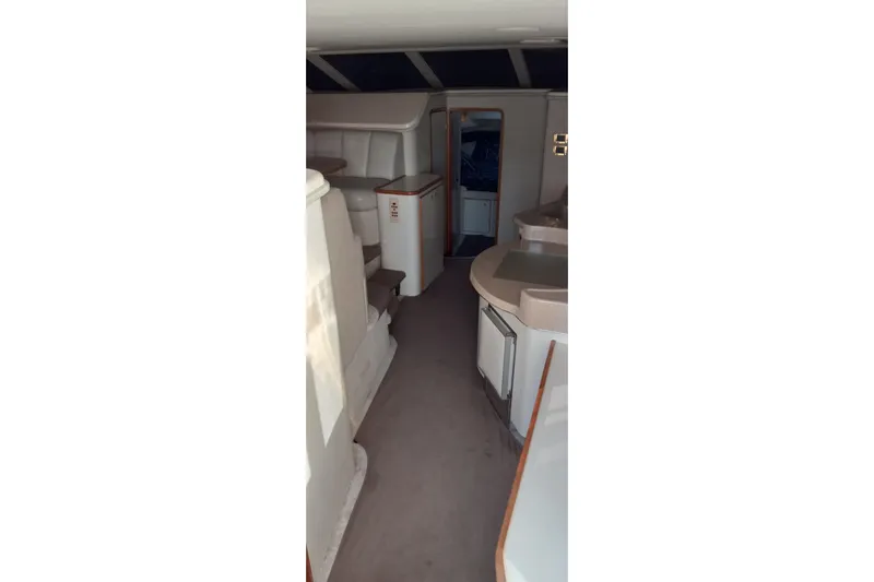 Slide: The Image of Interior of a 1997 Sea Ray 440 Express yacht, featuring a spacious cabin layout. - 9