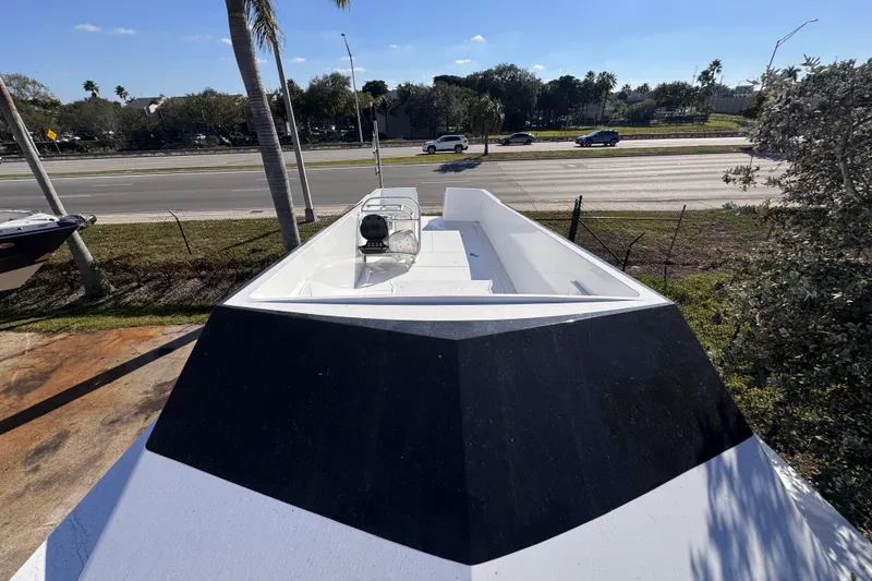 Slide: The Image of 2025 Don Smith Custom 55' boat on display near a highway, surrounded by trees. - 10