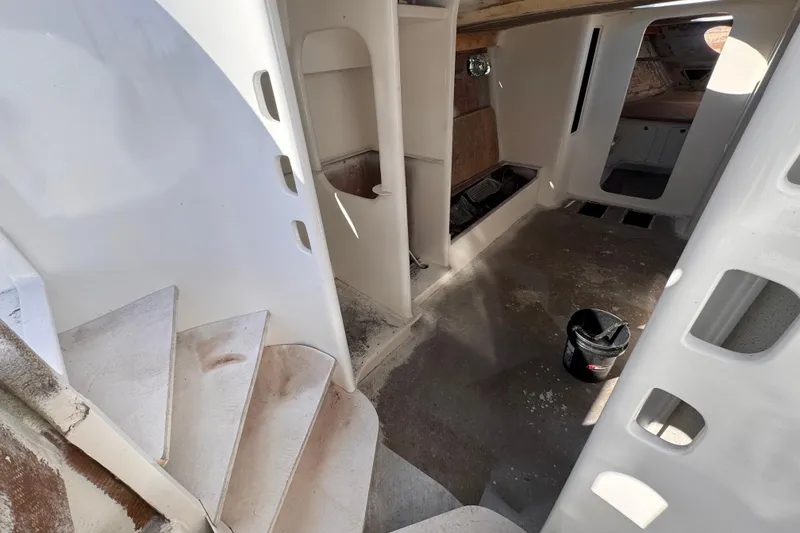 Slide: The Image of Interior of 2025 Don Smith Custom 55' yacht under construction, featuring stairs and unfinished surfaces. - 12