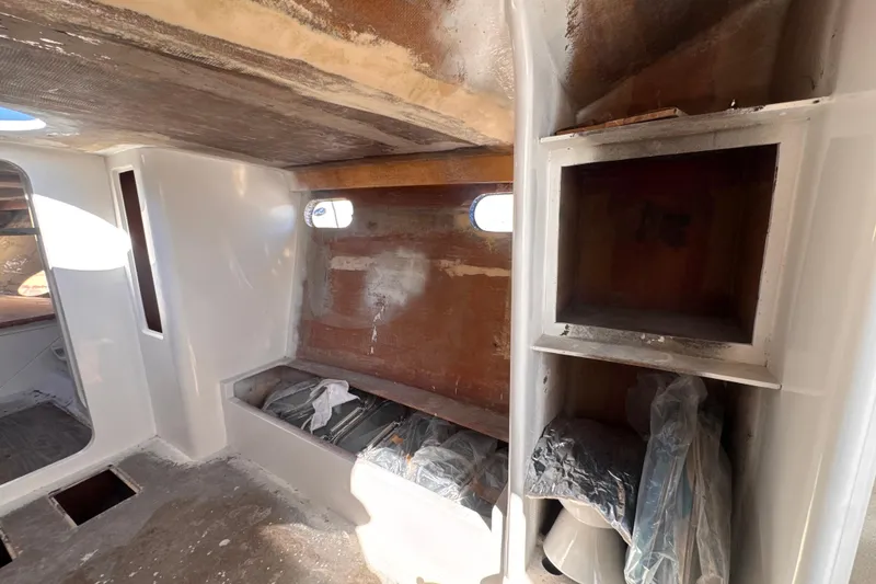 Slide: The Image of Interior of 2025 Don Smith Custom 55' boat under construction, showing unfinished cabin space. - 14