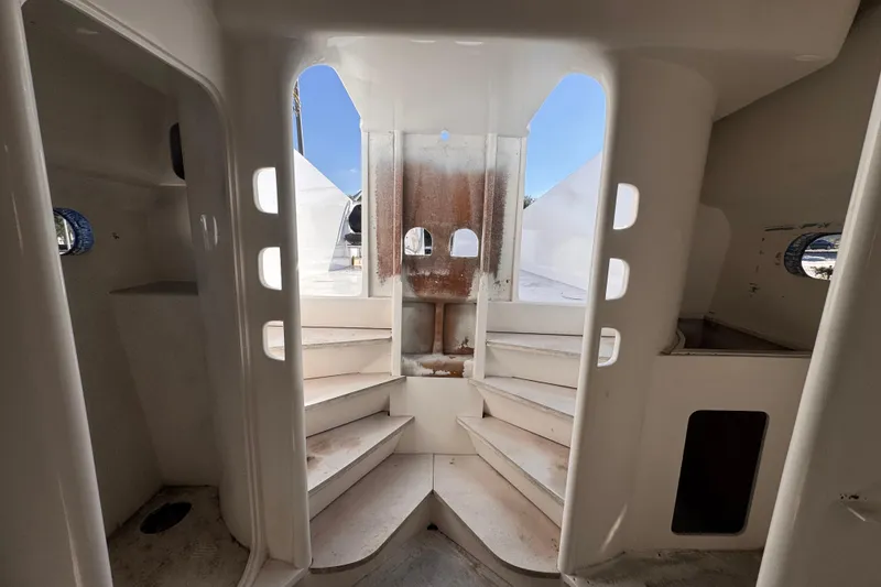 Slide: The Image of Interior view of 2025 Don Smith Custom 55' yacht, featuring white staircases and portholes. - 17