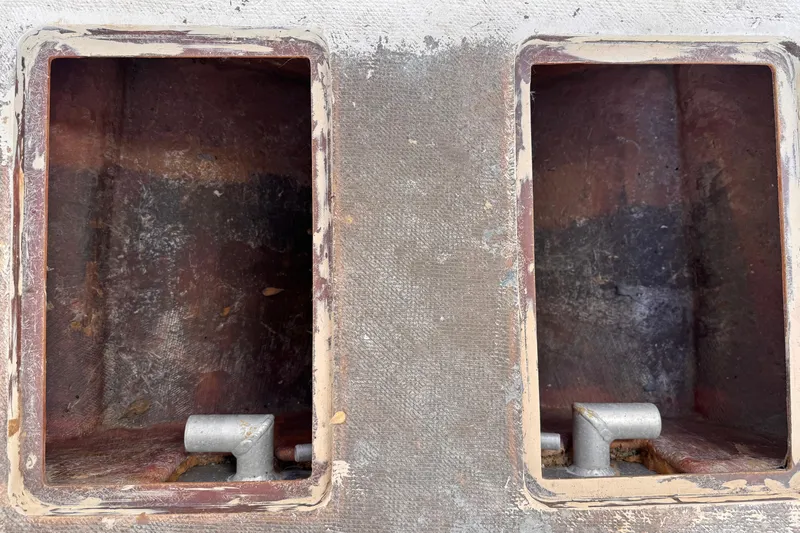 Slide: The Image of Interior compartments of a 2025 Don Smith Custom 55' boat, showing wear and metal fittings. - 19