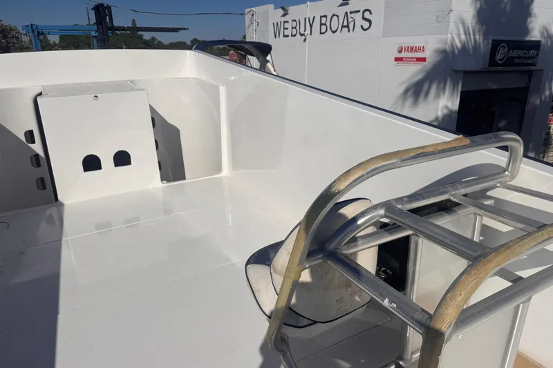 Slide: The Image of 2025 Don Smith Custom 55' boat deck with metal railing, near "We Buy Boats" sign. - 25
