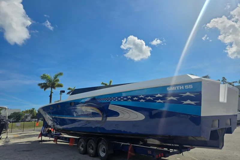 Slide: The Image of 2025 Don Smith Custom 55' boat on trailer under clear blue sky. - 5