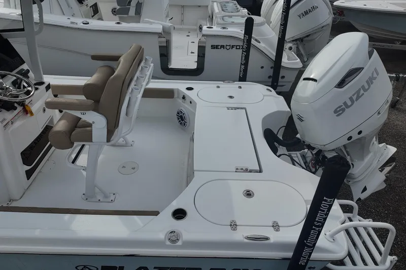 Slide: The Image of 2026 Blazer Bay 2440 boat interior with tan quilted seating and white console. - 11