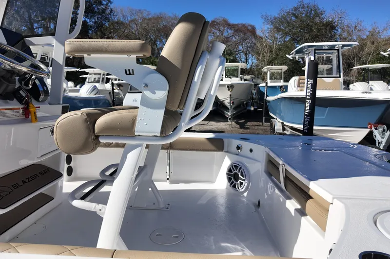 Slide: The Image of 2026 Blazer Bay 2440 boat interior with beige seating and steering wheel. - 15