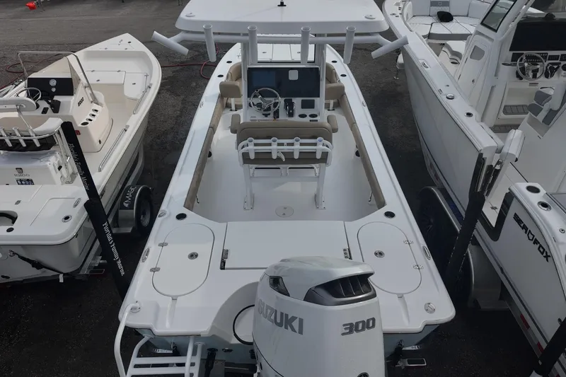 Slide: The Image of 2026 Blazer Bay 2440 boat on trailer, parked outdoors under clear blue sky. - 3