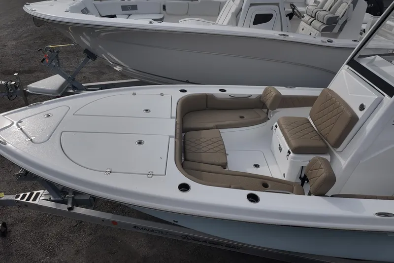 Slide: The Image of 2026 Blazer Bay 2440 boat with beige seating and spacious deck layout. - 7