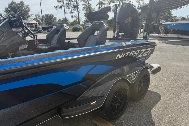 Slide: The Image of 2024 Nitro Z21 XL Pro boat with sleek design and dual seats in a sunny outdoor setting. - 2