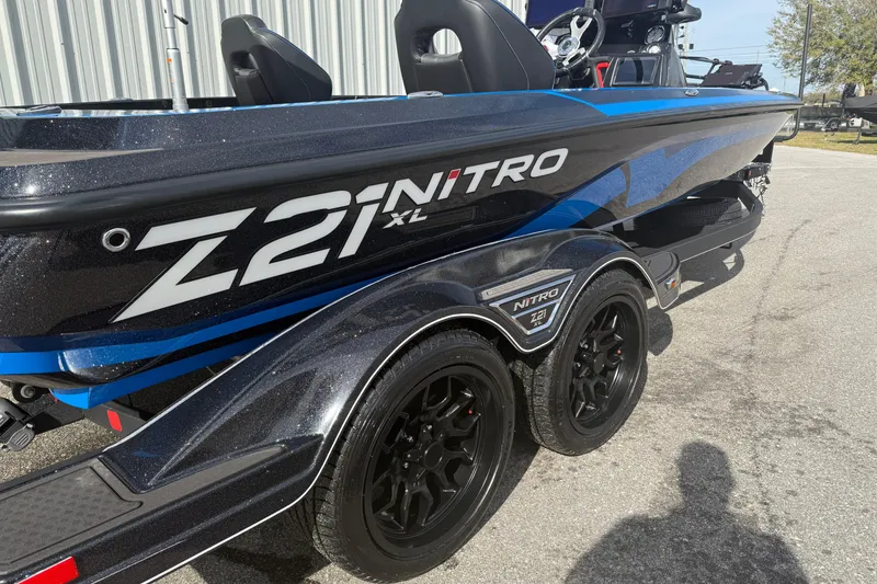 Slide: The Image of 2024 Nitro Z21 XL Pro boat with sleek design and dual axle trailer. - 3