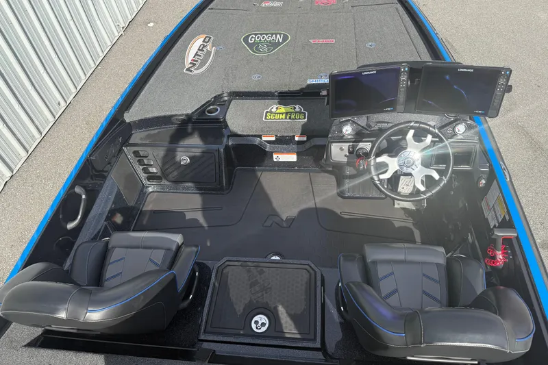 Slide: The Image of 2024 Nitro Z21 XL Pro boat interior with dual screens and black leather seats. - 4
