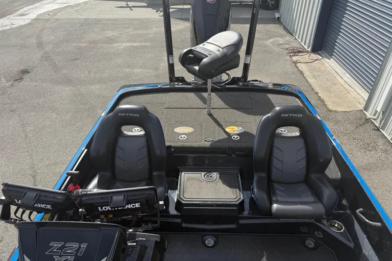 Slide: The Image of 2024 Nitro Z21 XL Pro boat interior with dual seats and fishing equipment. - 5