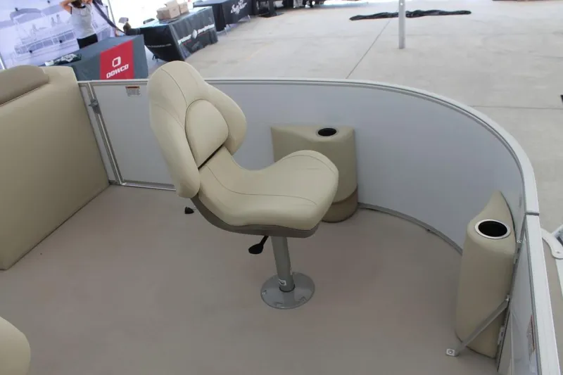 Slide: The Image of 2023 Starcraft EX 18 boat interior with beige seating and cup holders. - 8