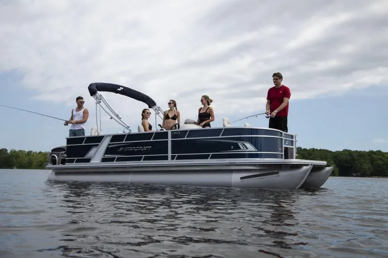 Slide: The Image of 2023 Starcraft EX 20 pontoon boat with people fishing on a lake. - 2