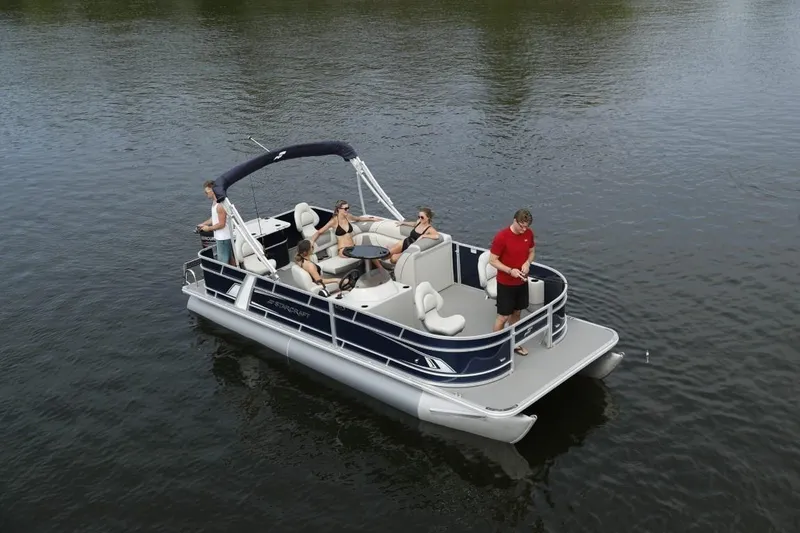 Slide: The Image of 2023 Starcraft EX 20 pontoon boat with passengers on a calm lake. - 5