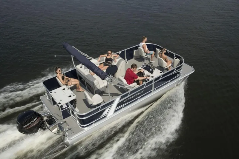 Slide: The Image of 2023 Starcraft EX 20 pontoon boat cruising with passengers on a lake. - 6