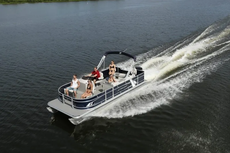 Slide: The Image of 2023 Starcraft EX 22 pontoon boat cruising on a lake with passengers. - 6